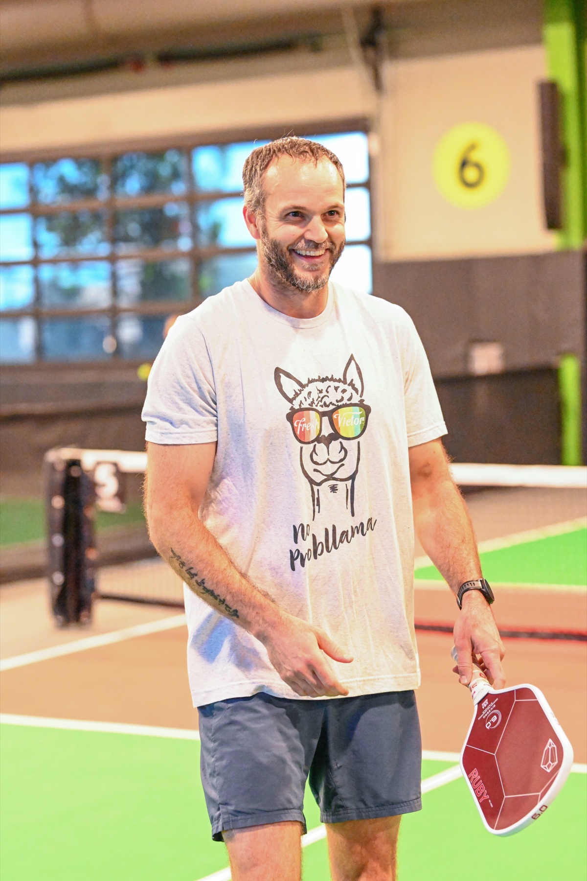 Jeff smiling on a pickleball court with a paddle